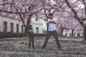 father and son in front of cherry blossoms